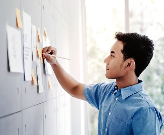 An Apastron engineer mapping a delivery plan on a wall of notes